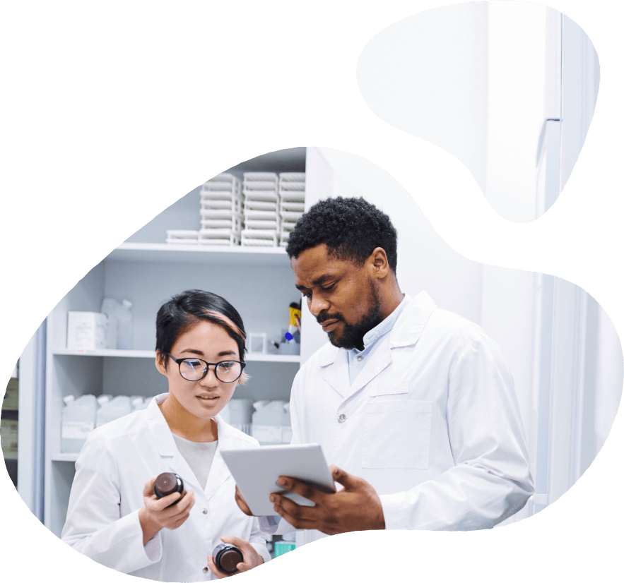 Two pharmacists looking at a tablet.